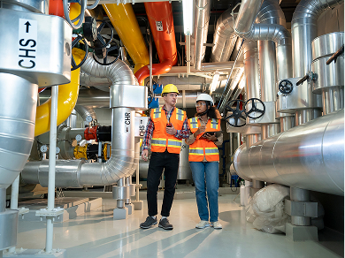 Engineers inspect CHS-labeled industrial pipes
