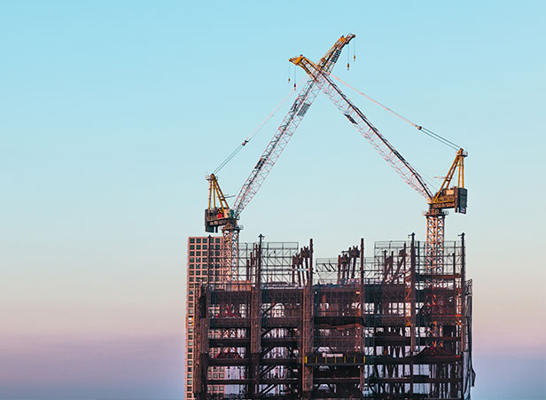 tall buildings with cranes